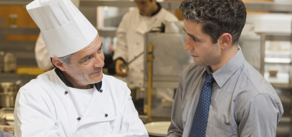 chef and restaurant manager talking