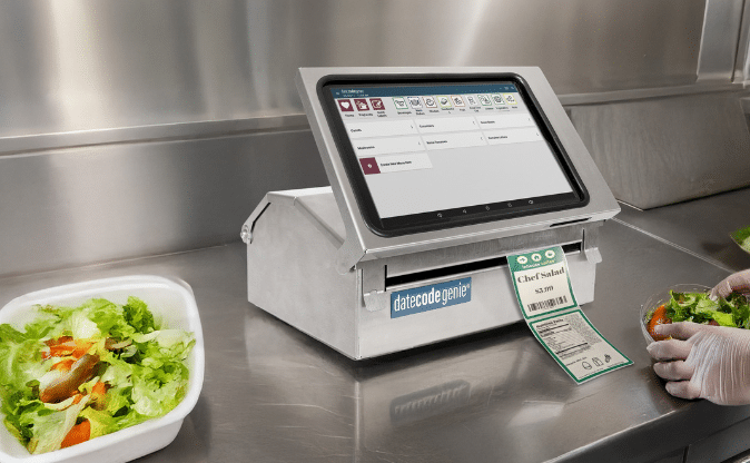 DateCodeGenie® automated food label printer creating salad labels in a convenience store kitchen.