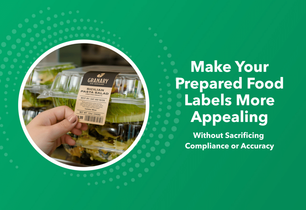 A custom-branded prepared foods label on a packaged retail pasta salad container held by an operator in a specialty grocery store marketplace
